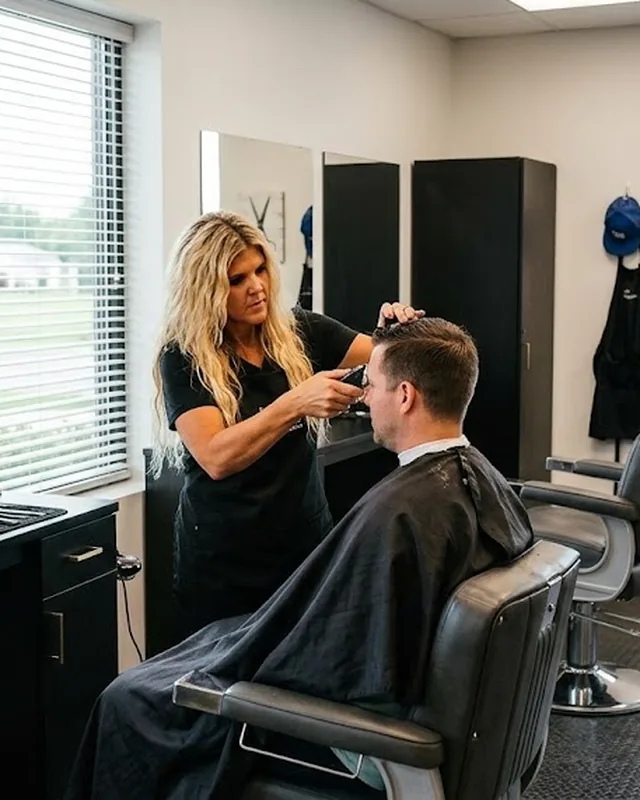 Jill cutting a client's hair at her styling station inside Jillz Barber Shop & Salon.