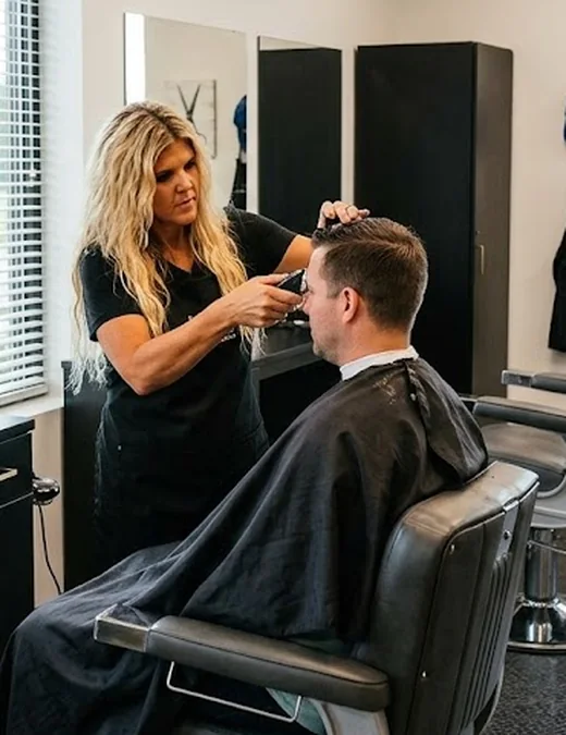 Jill, owner and stylist, cutting a client at Jillz Barber Shop & Salon